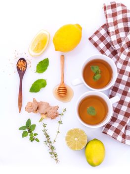 Cups of herbal  tea with aromatic herbal with lemon , lime and honey .