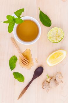 Cups of herbal  tea with aromatic herbal with lemon , lime and honey .