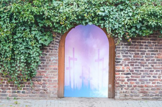 Photomontage, an entrance gate in a wall in a park. Behind the gate open the gateway to heaven.