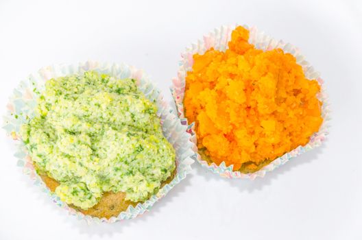Two muffins with fresh fruit and vanilla pod on a light background