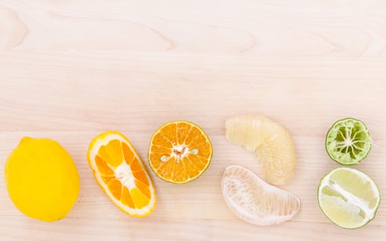 Mixed citruses fruit oranges, pomelo , lemon and lime on wooden background.