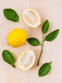 Fresh lemons and o lemons  slice on wooden background with  lemons  leaf.