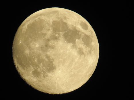 Full round clestial moon in black evening sky. Clear planet with craters