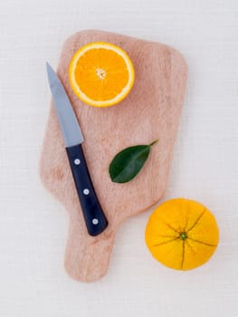 Mixed citruses fruit oranges, lemon on wooden background with orange leaf.