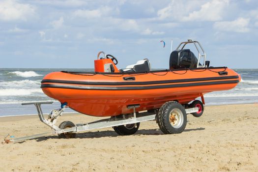 Boat for emergency services on a trailer  at shore with beach and sea