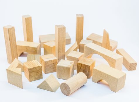 Different shapes of wooden building blocks for construction isolated on white background