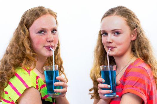 Two caucasian teenagers drinking blue soda with straws isolated on white background