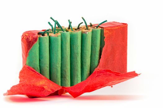 Standing green firecrackers in packet with red paper isolated on white background