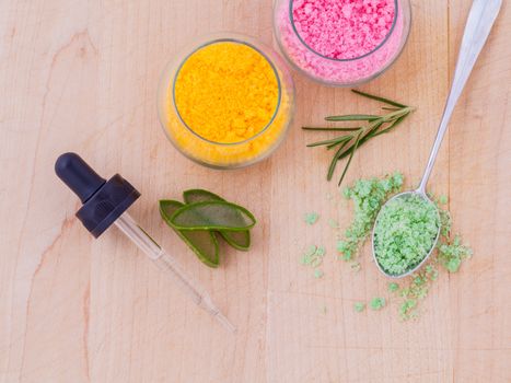 The spa ingredient sea salt and herb on wooden table .