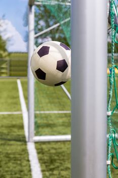 Football shot between goalposts on football field