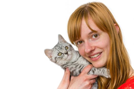 European redhead teenage girl hugging young black silver tabby cat isolated on white background