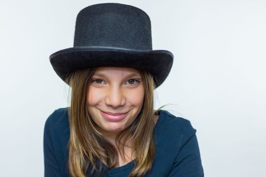 Caucasian teenage girl in black wearing top hat isolated on white background