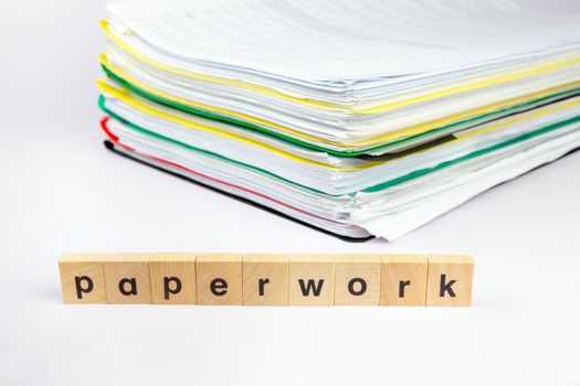 Stack of papers with word paperwork on wooden blocks