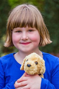 Young dutch girl holding hugging stuffed dog