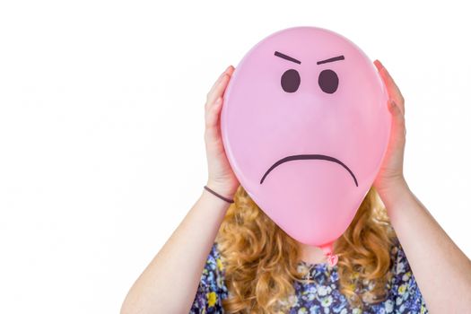Pink balloon with frustrated expression in front  of girls face