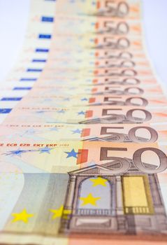 Series of 50 euro notes in a row as symbol of money and wealth