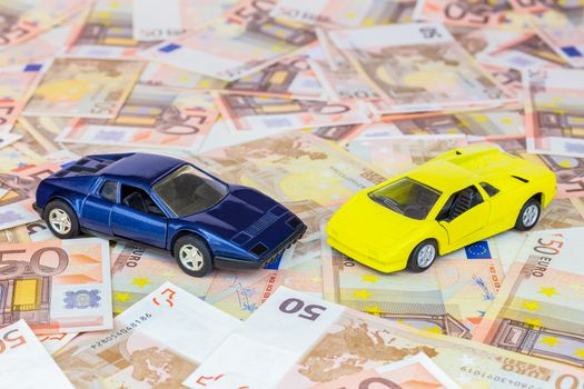 Two model cars on 50 euro notes as symbol for luxury and wealth