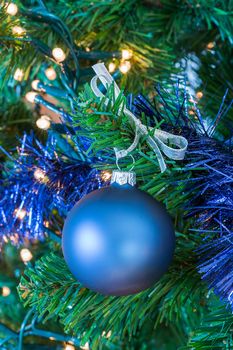 Blue Christmas ball or bauble  hanging in tree as decoration