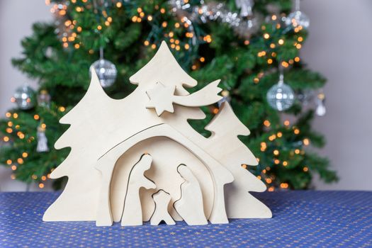 Blank wooden christmas crib with christmas tree as decoration