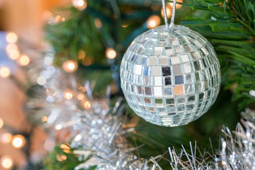 Christmas ball or bauble with little mirrors as decoration hanging in tree