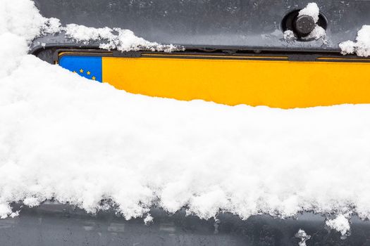 Dutch car license plate with snow in winter season