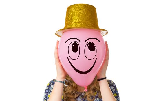 Girl holding balloon with expression of smiling face and gold hat isolated on white background