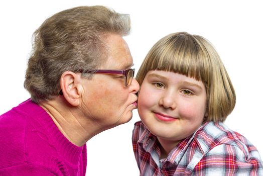 Caucasian grandmother kisses granddaughter on cheek isolated on white background