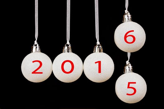 White christmas balls or baubles with dates 2015 old year and 2016 new year on black background