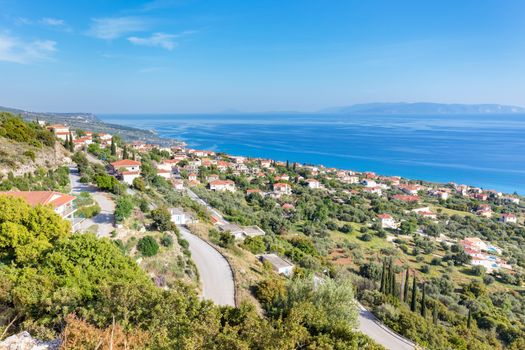 Greek village showing houses at coast near blue sea in Kefalonia Greece