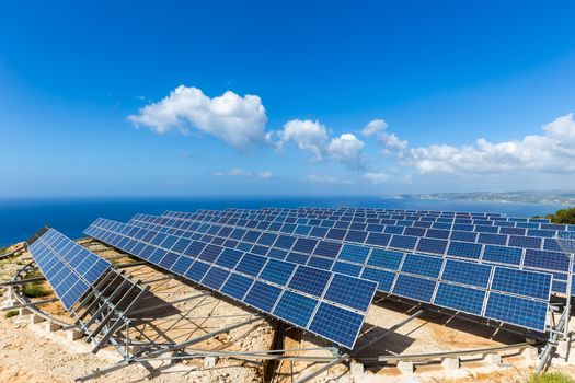 Field of many solar collectors in rows on rotatable circular construction at coast in Kefalonia Greece