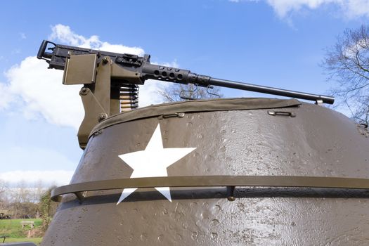 Machine gun on old american tank with blue sky on sunny day