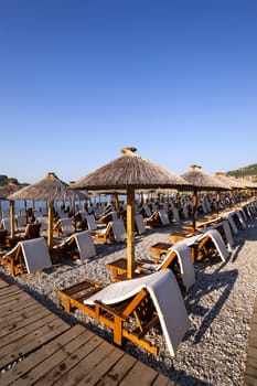  the photographed wooden umbrellas located in the territory of a beach