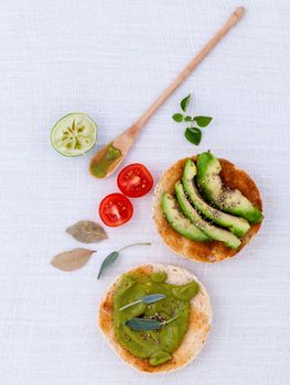 Toast with avocado creamy salad and herbs  on white table.