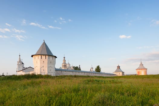 Spaso-Prilutsky monastery, blue sky and green meadow in summer Russia Vologda