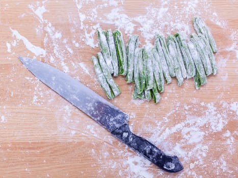 Preparation homemade pasta on wooden table.