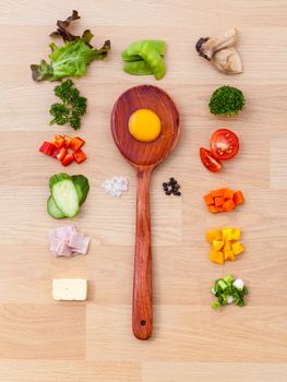 Ingredients of homemade omelet on wooden panel.
