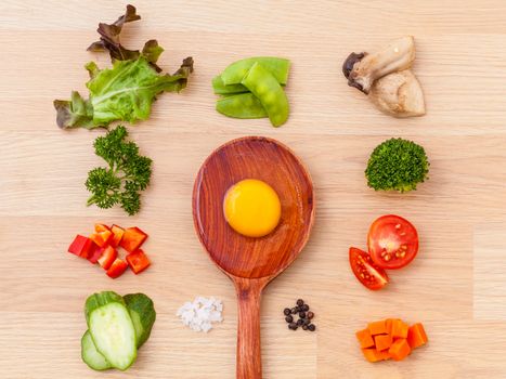 Ingredients of homemade omelet on wooden panel.