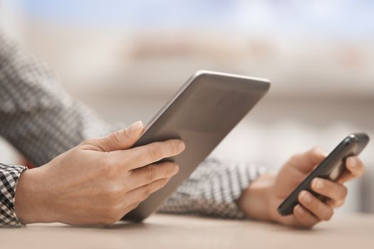 Businesswoman at office with digital tablet and smartphone