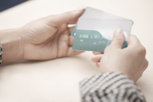 Woman holding two plastic credit cards. Horizontal photo