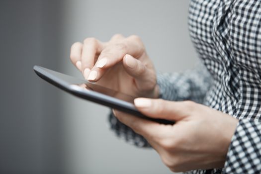Womanworking with digital tablet. Close-up horizontal photo