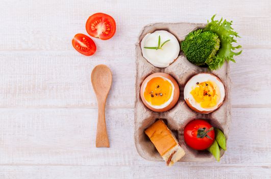 Boiled eggs for breakfast on wooden table.