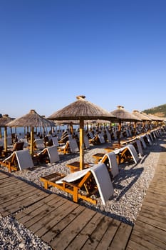  the photographed wooden umbrellas located in the territory of a beach