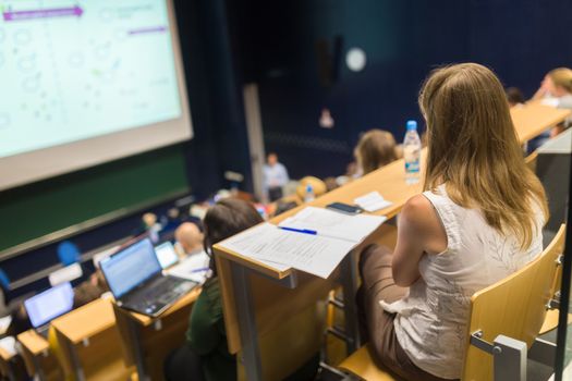 Conference and Presentation. Audience at the conference hall. Business and Entrepreneurship. Faculty lecture and workshop. Audience in the lecture hall. Academic education. Student making notes.