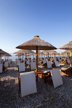  the photographed wooden umbrellas located in the territory of a beach