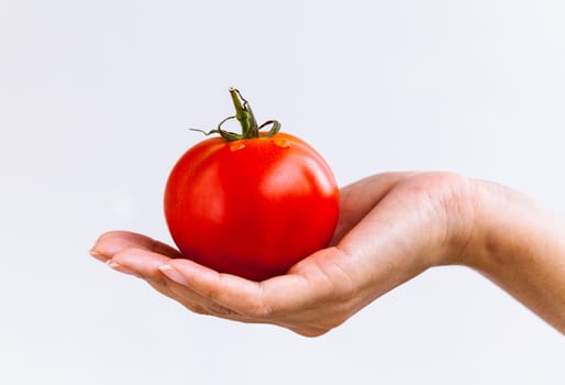 The Girl holding tomato. - Healthy food concept.