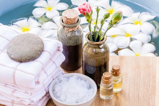 Spa and wellness treatment setup on wooden panel.