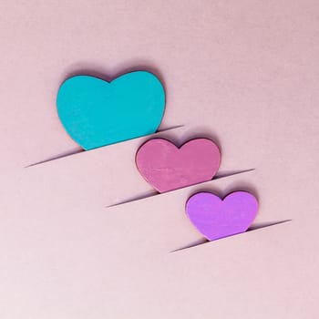 The wooden hearts on cardboard background. - Concept for love and wedding .