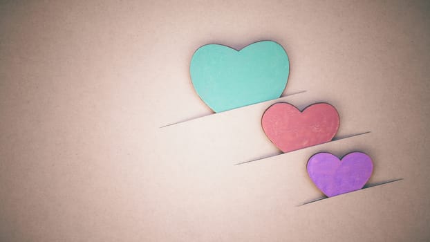 The wooden hearts on cardboard background. - Concept for love and wedding .