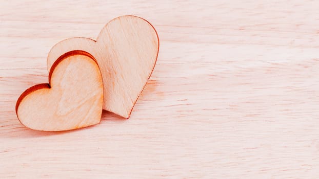The wooden hearts on wooden background. - Concept for love and wedding .