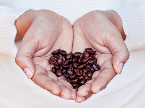 Hand of women holding coffee beans . - Concept for giving refreshing.